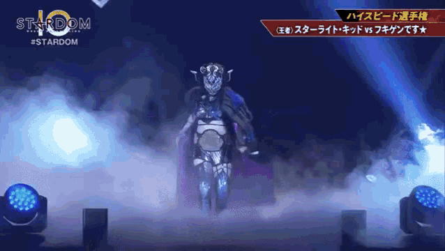 a person in a stardom costume stands in front of a stage