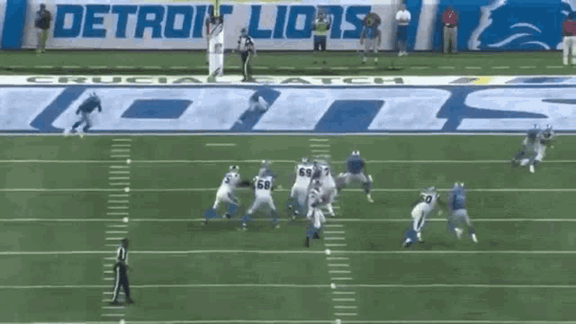 a football game is being played in front of a banner for detroit lions