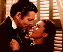 a man and a woman are dancing together in front of a window .