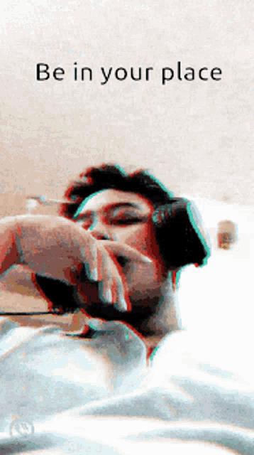a man laying on a bed with the words be in your place behind him