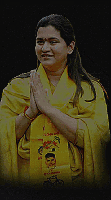 a woman wearing a yellow shirt with the word kesineni on it