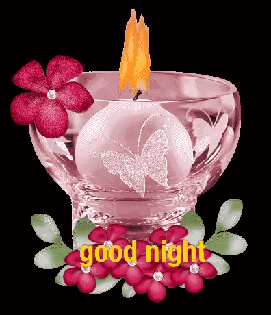 a candle is in a glass with flowers and the words good night