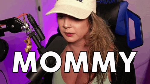 a woman wearing a hat is sitting in front of a microphone with the word mommy above her