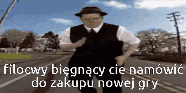 a man in a hat and vest is running down a street with the words filocwy biegnacy cie namówic