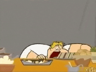 a cartoon man with a mustache is holding a piece of food in his hands while sitting at a table .
