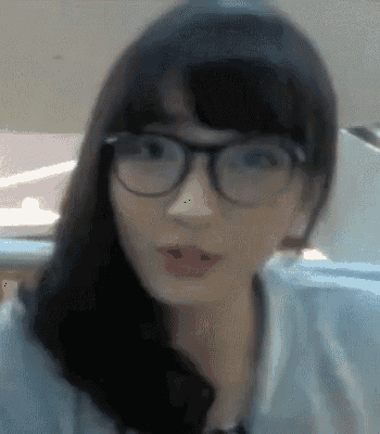 a woman wearing glasses looks at the camera
