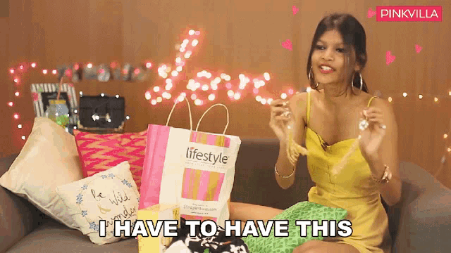 a woman is sitting on a couch with a lifestyle bag