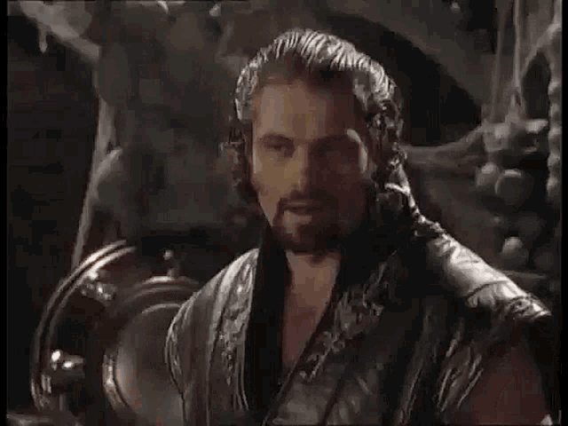 a man with a beard and a leather vest says now i 'm flesh again and it feels