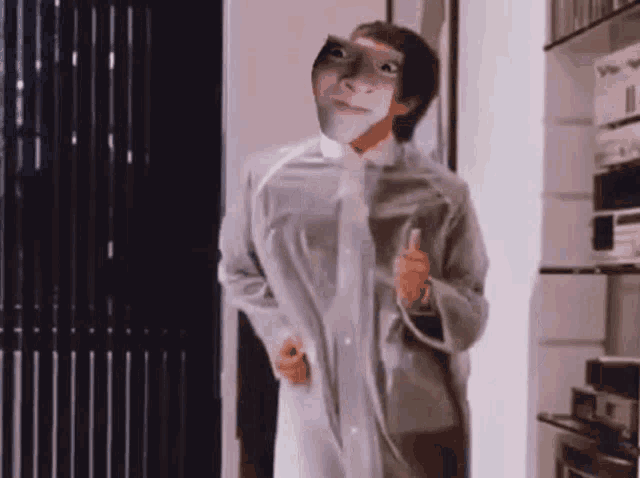 a man with a mask on his face is standing in a doorway