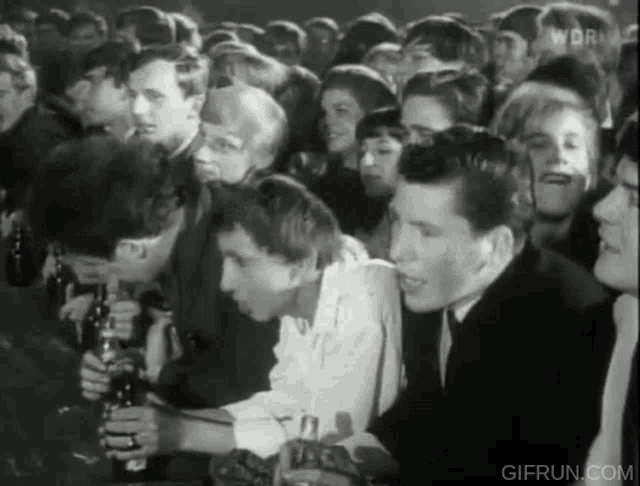 a black and white photo of a crowd with the words gifrun.com on the bottom right