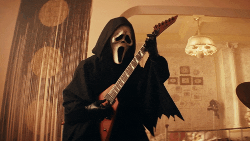 scream is playing a guitar in a room