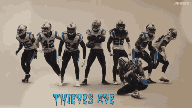 a group of football players standing in a row with thieves ave written on the bottom