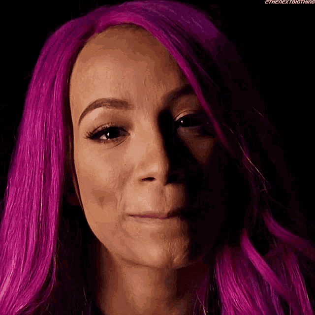 a close up of a woman with purple hair making a face
