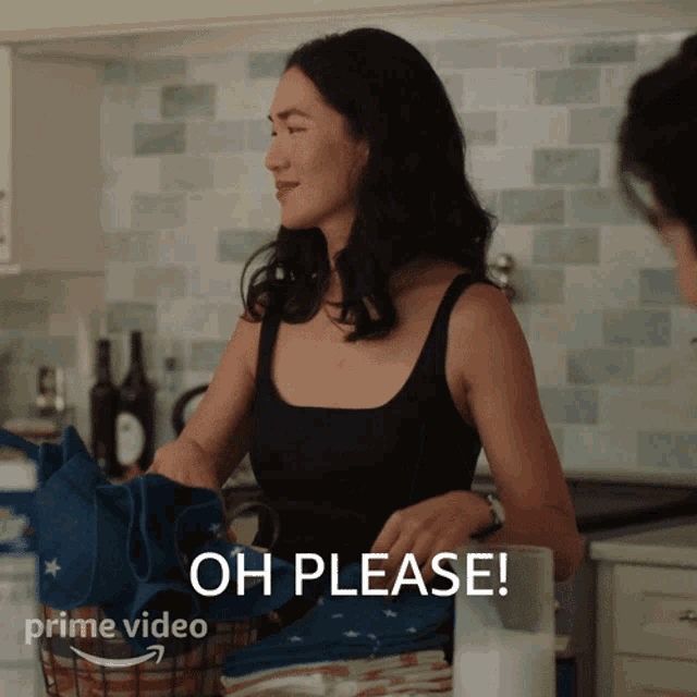 a woman in a black tank top is sitting at a counter and says oh please
