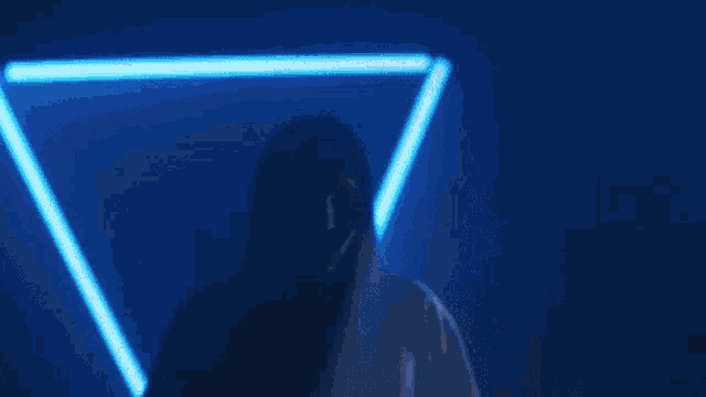 a blurry picture of a man playing a guitar in a dark room