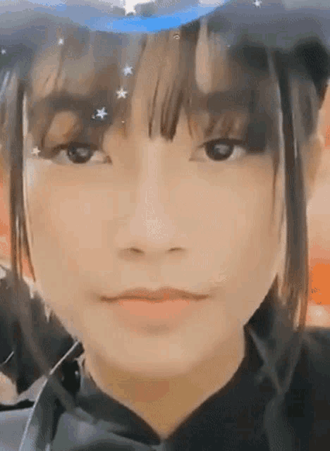 a close up of a woman 's face with a witch hat on .
