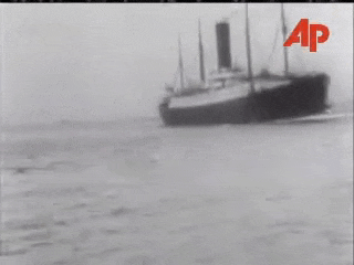 a black and white photo of a ship in the water
