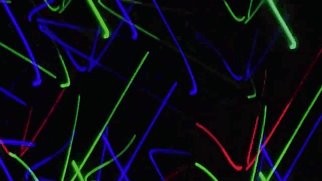 a bunch of colorful lights are glowing in the dark .