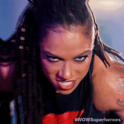 a close up of a woman with dreadlocks and the words wowsuperheroes