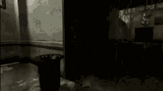 a person is standing in front of a trash can in a dark room in a video game .