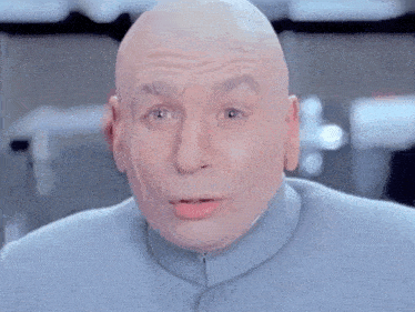 a bald man in a blue suit is making a surprised face .