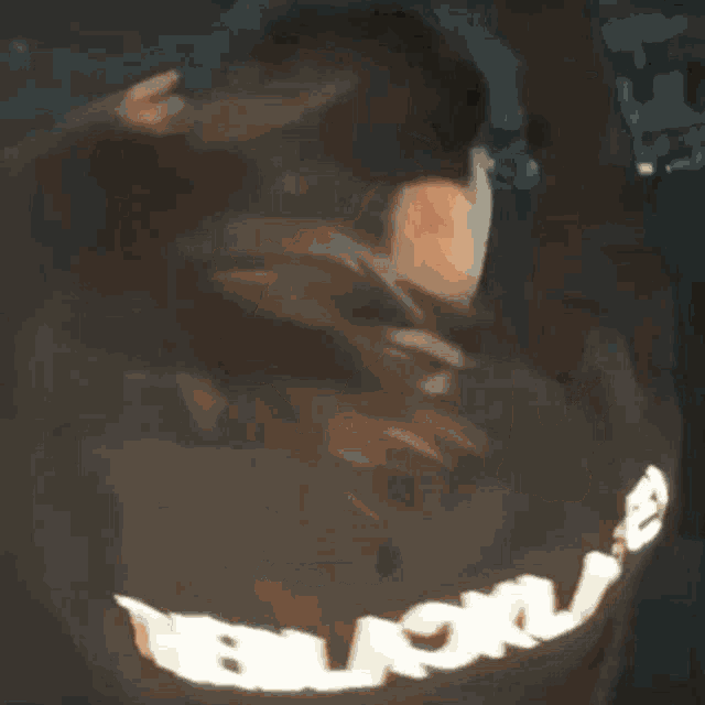 a woman wearing a black shirt with the word balenciaga on it