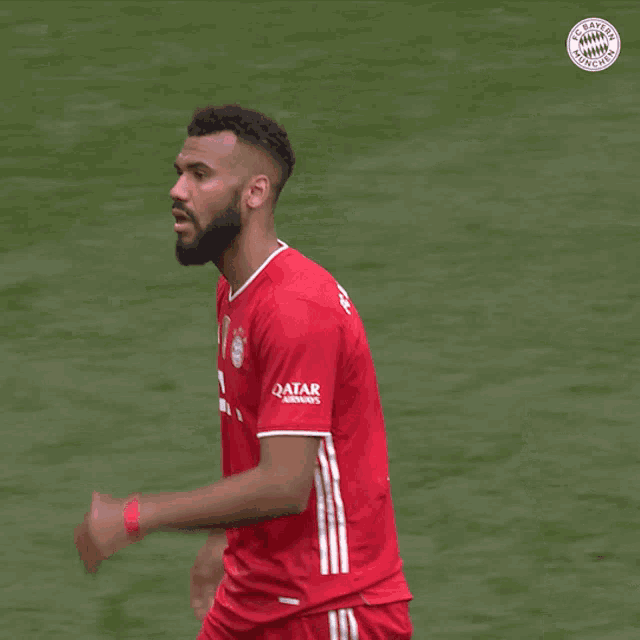 a soccer player wearing a red shirt with the number 13