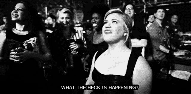 a black and white photo of a woman asking what the heck is happening ..