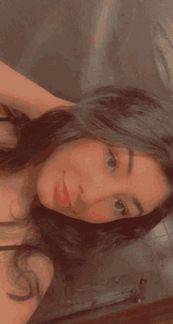 a close up of a woman 's face with long hair and red lips