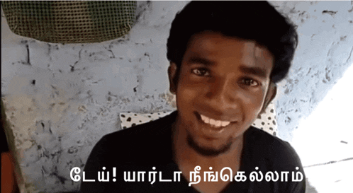 a man in a black shirt is smiling in front of a sign that says ' o '