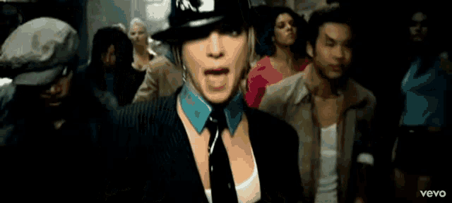 britney spears is wearing a fedora and tie in a video for vevo