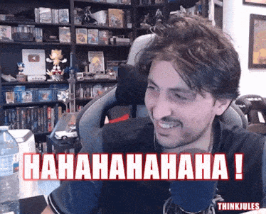 a man sitting in front of a microphone with the words ' hahahaha ! ' on the bottom
