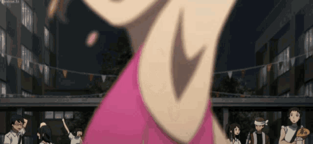 a woman in a pink shirt is dancing in front of a crowd of people .