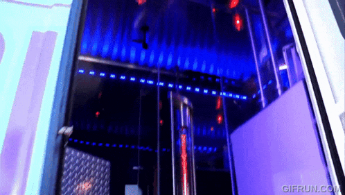 a gif from gifrun.com shows a dark room with purple lights