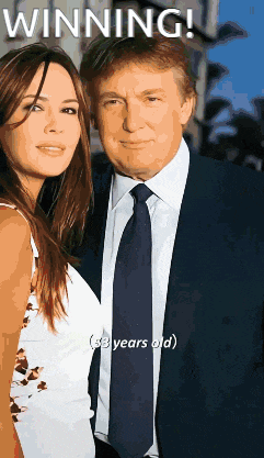 a man in a suit and tie is standing next to a woman with the caption winning
