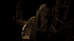a woman in a video game is holding a ring in her hand