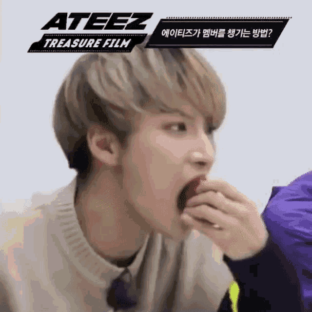 a young man is eating a red apple .