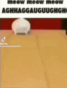 a cartoon cat is walking on a wooden floor next to a vase .