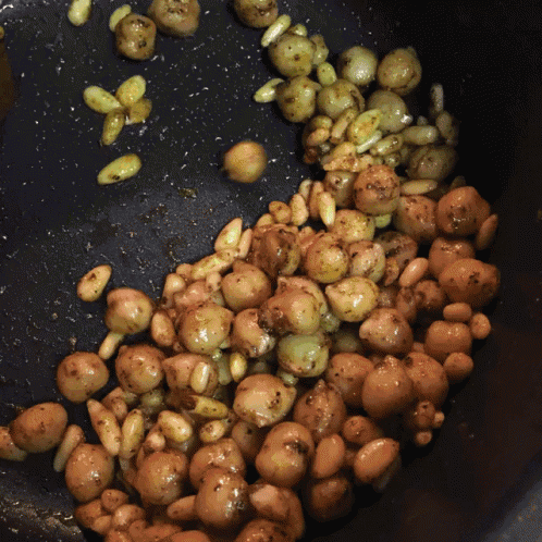 nuts are being cooked in a frying pan with oil