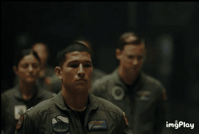 a man in a military uniform has a patch on his jacket that says falcon