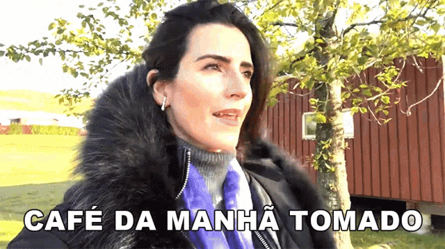 a woman in a fur coat says cafe da manha tomado in a foreign language