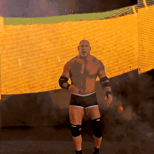 a shirtless wrestler is standing in front of a large screen that says wwe on it