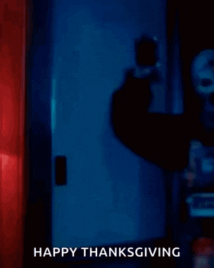 a clown with blood on his face is holding a pot of food and says `` happy thanksgiving '' .