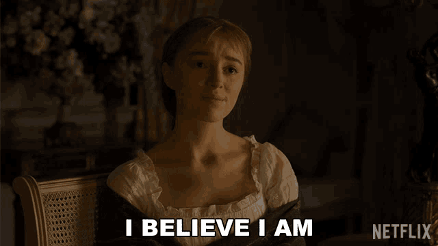 a woman says i believe i am while sitting in a chair