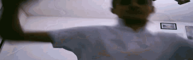 a man in a white shirt is standing in a room with his arms outstretched