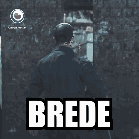 a man standing in front of a brick wall with the word boke on the bottom