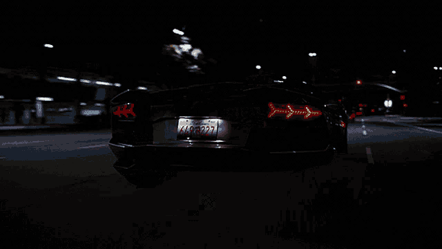 a busy intersection at night with a sign that says ' downtown '
