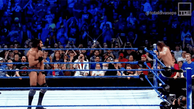 a man in a wrestling ring with the words totaldivaseps on the bottom left
