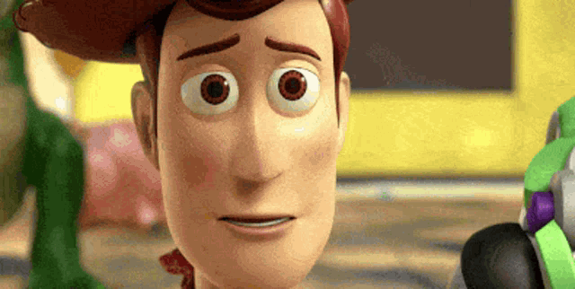 a close up of a toy story character 's face with buzz lightyear in the background