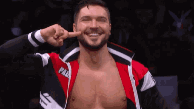a wrestler wearing a red and black jacket with the word pad on it